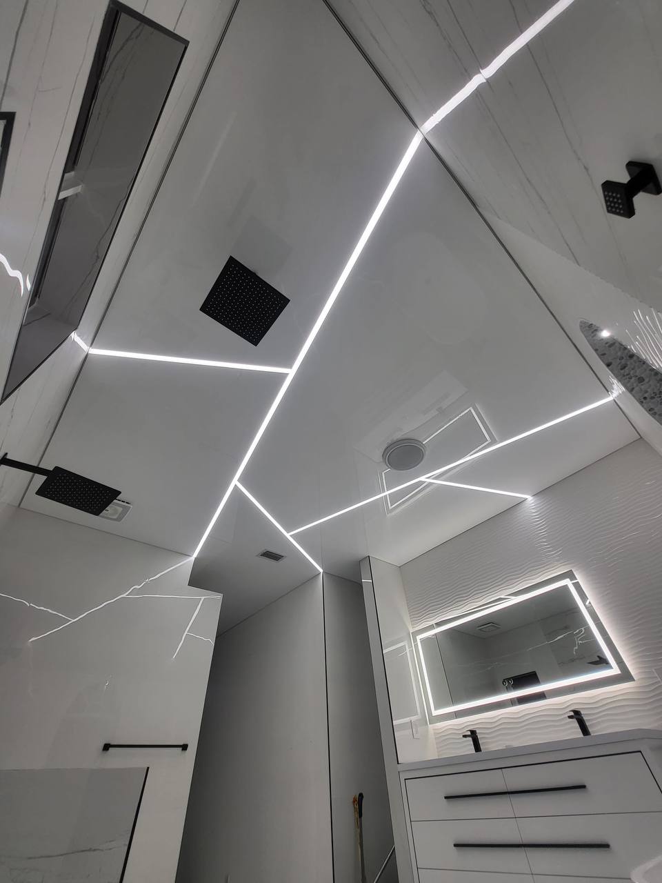 Bathroom with geometric LED ceiling and marble walls